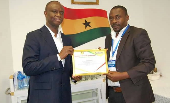 Mr Joe Anokye (left) receiving the citation from the CEO of Humanity Magazine International, Mr Yahaya Alhassan 
